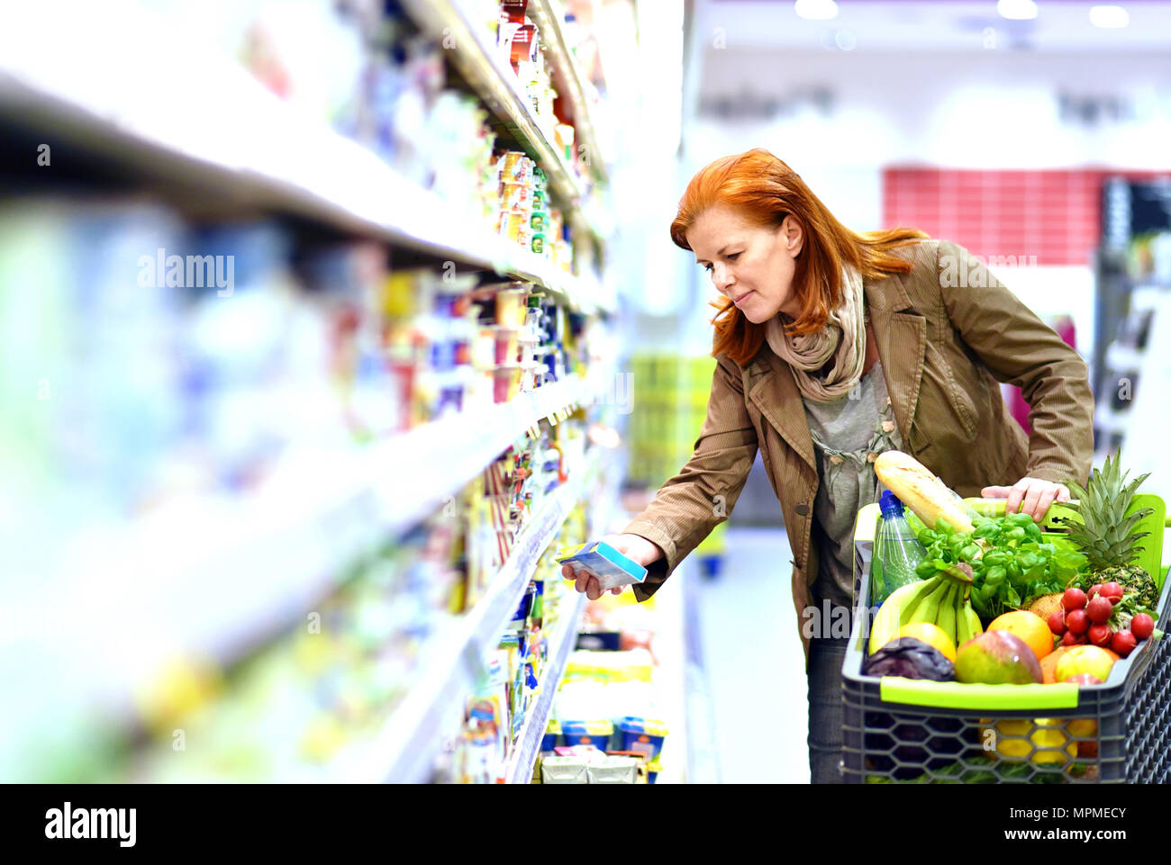 elderly pretty woman shopping for fresh healthy food in the supermarket Stock Photo
