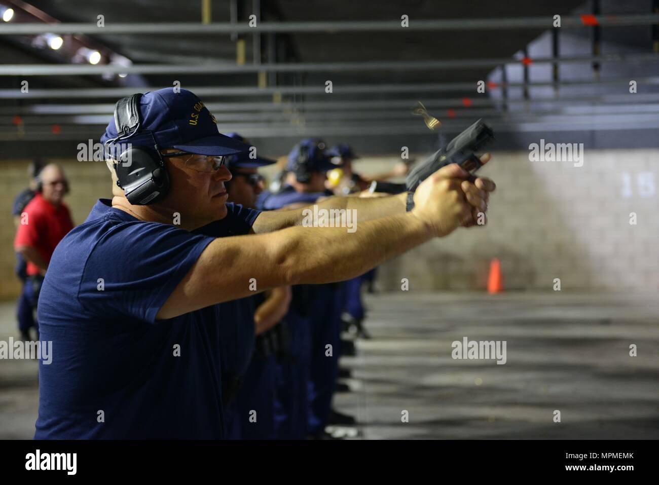 Chief Petty Officer Wesley Mundy, a maritime enforcement specialist at Coast Guard Sector Honolulu, conducts a live fire exercise during a Firearms Training and Evaluation – Pistol course at the Dexter Small Arms Firing Range at Coast Guard Base Honolulu, March 28, 2017. The FT&E-P, which will replace the Basic Pistol Marksmanship Course, will qualify Coast Guard law enforcement personnel using a four-phased approach of training, practice, qualification and proficiency. (U.S. Coast Guard photo by Petty Officer 2nd Class Tara Molle/Released) Stock Photo