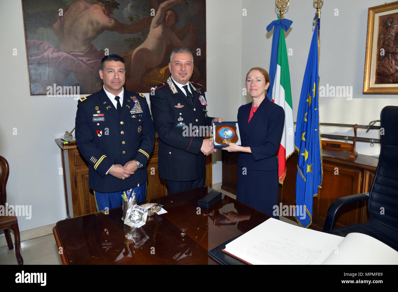 Brig. Gen. Giovanni Pietro Barbano, Center of Excellence for Stability Police Units (CoESPU) director (center) and U.S. Army Col. Darius S. Gallegos, CoESPU deputy director (left), presents  Carabinieri CoESPU crest to Ms. Kelly Degnan, Charge’ d’Affaires ad interim U.S. Embassy & Consulates Italy,  during visit at Center of Excellence for Stability Police Units (CoESPU) Vicenza, Italy, Mar. 30, 2017.(U.S. Army Photo by Visual Information Specialist Antonio Bedin/released) Stock Photo