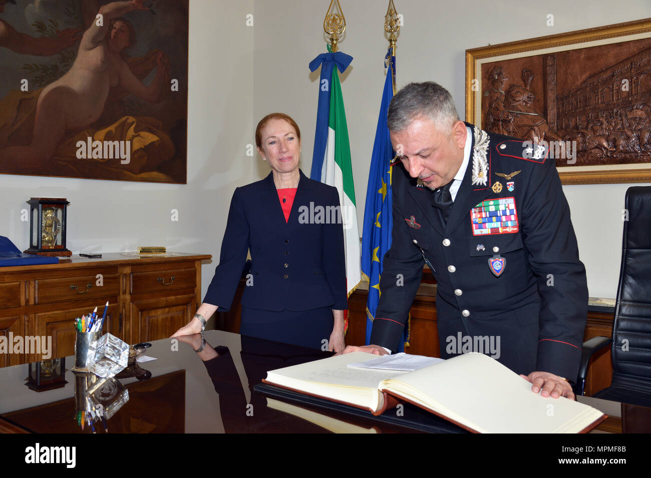 Brig. Gen. Giovanni Pietro Barbano, Center of Excellence for Stability Police Units (CoESPU) director, reads note in guest of honor book, written by Ms. Kelly Degnan, Charge’ d’Affaires ad interim U.S. Embassy & Consulates Italy, during visit at Center of Excellence for Stability Police Units (CoESPU) Vicenza, Italy, Mar. 30, 2017. (U.S. Army Photo by Visual Information Specialist Antonio Bedin) Stock Photo