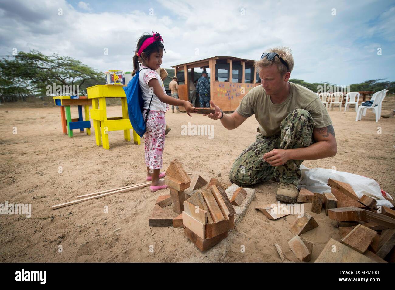 170330-N-YL073-212 MAYAPO, Colombia (March 30, 2017) - Utilitiesman 2nd Class Elliott Shultz, a native of Indianapolis assigned to Construction Battalion Maintenance Unit (CBMU) 202, Norfolk, Va., plays with a child from a Wayuu tribe in Mayapo, Colombia, during Continuing Promise 2017 (CP-17). CP-17 is a U.S. Southern Command-sponsored and U.S. Naval Forces Southern Command/U.S. 4th Fleet-conducted deployment to conduct civil-military operations including humanitarian assistance, training engagements, medical, dental, and veterinary support in an effort to show U.S. support and commitment to  Stock Photo