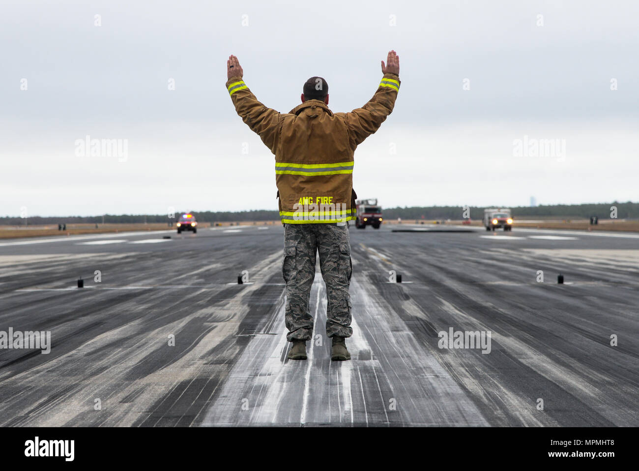 U.S. Air Force Master Sgt. Steve Greenwood from the 177th Civil Engineering Squadron Fire Department works to reset the cable arrest system after a test April 1, 2017, at the 177th Fighter Wing at Atlantic City Air National Guard Base, N.J. The arrest system is used to stop aircraft in the event of a brake failure and must be tested yearly. (U.S. Air National Guard photo by Senior Airman Shane Karp/Released) Stock Photo