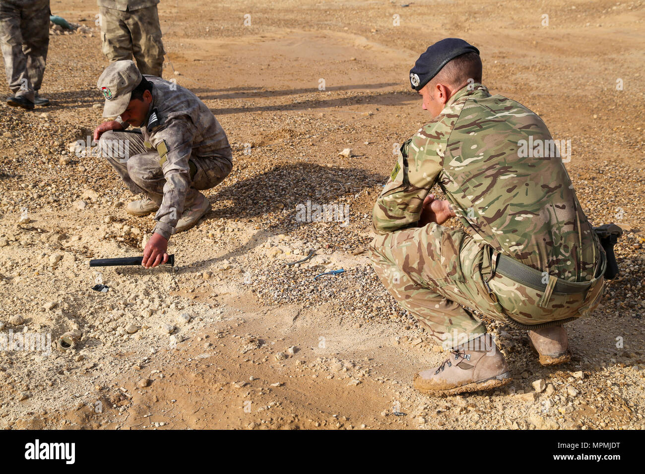 An Iraqi security forces soldier scans for hidden improvised explosive devices under the guidance of a British trainer, deployed in support of Combined Joint Task Force – Operation Inherent Resolve, during counter-IED training at Al Asad Air Base, Iraq, March 29, 2017. This training is part of the overall CJTF- OIR building partner capacity mission by training and improving the capability of partnered forces fighting ISIS. CJTF-OIR is the global Coalition to defeat ISIS in Iraq and Syria. (U.S. Army photo by Sgt. Lisa Soy) Stock Photo
