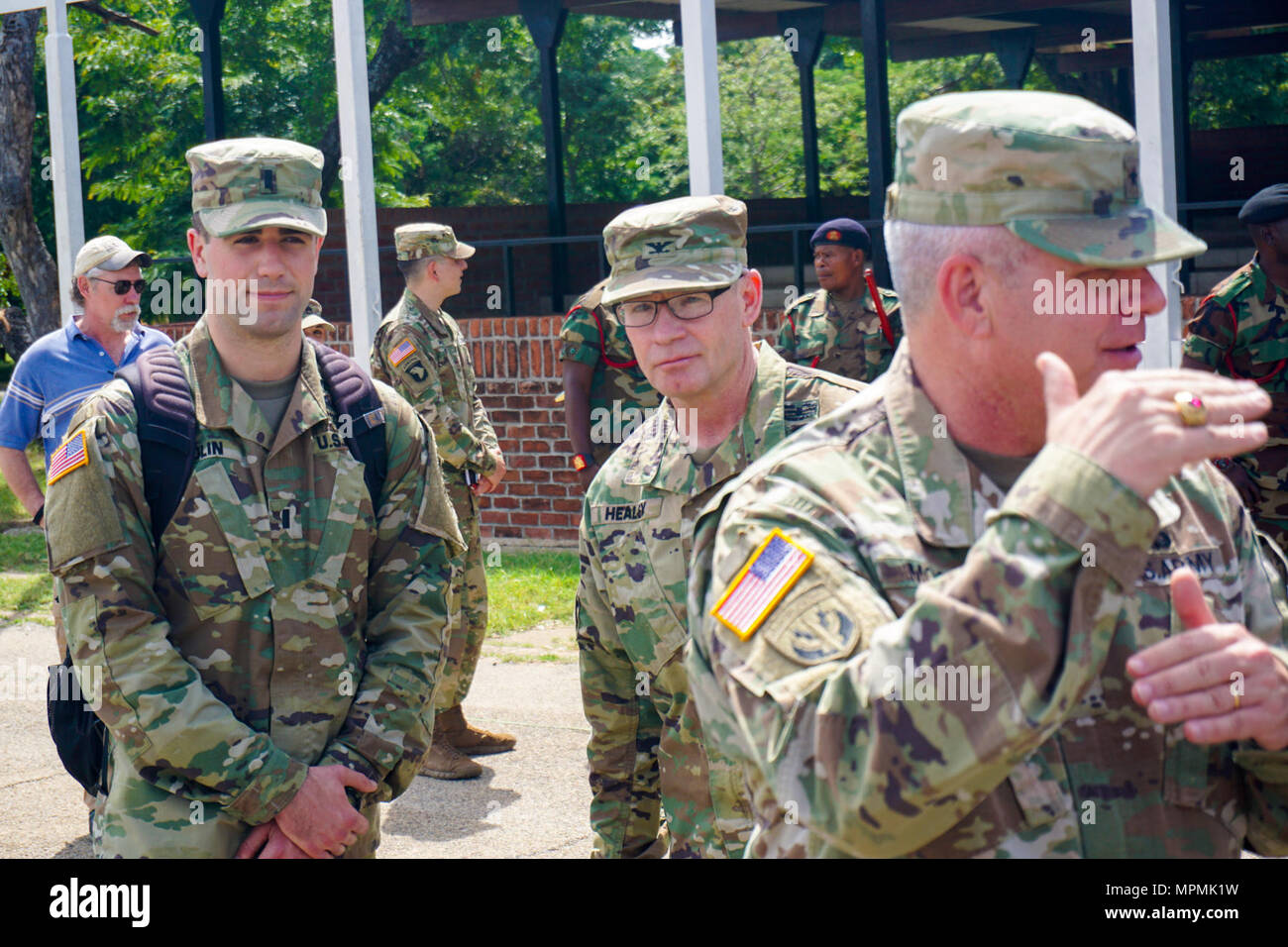 U.S. Army 1st Lt. Christopher Bolin, aide to the U.S. Army Africa deputy commander, stands ready behind U.S. Army Brig. Gen. Kenneth Moore, U.S. Army Africa deputy commander, near the Malawi Armed Forces College, Salima, Malawi, during the final planning event for the Africa Land Forces Summit 2017, March 28, 2017. ALFS is an annual, weeklong seminar bringing together land force chiefs from across Africa for candid dialog to discuss and develop cooperative solutions to regional and trans-regional challenges and threats. Stock Photo