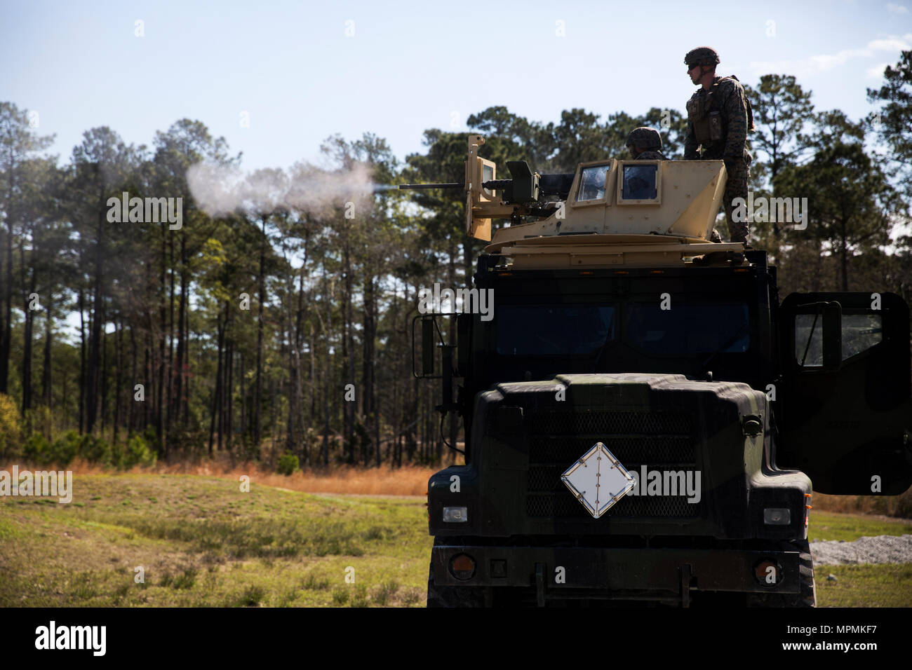 Cpl. Zachary Taylor instructs a Marine on how to use an M2 Browning .50-caliber machine gun at Camp Lejeune, N.C., March 30, 2017. The Marines conducted a live-fire from the turrets of Medium Tactical Vehicle Replacement trucks, as part of a culminating event for the Combat Logistics Regiment 25 Command Post Exercise. Taylor is with the Battle Skills Training School, 2nd Marine Logistics Group. (U.S. Marine Corps photo by Pfc. Taylor W. Cooper) Stock Photo