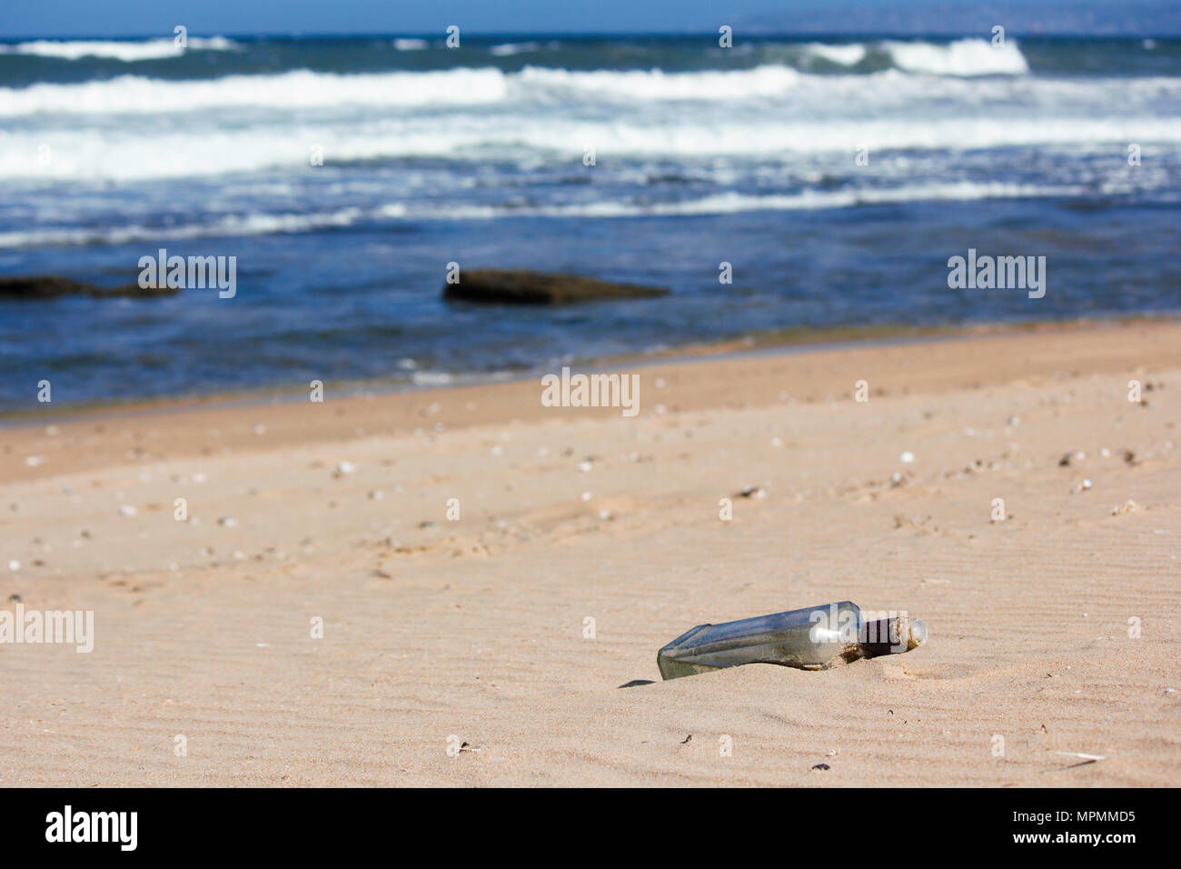 Glass Bottle On A Sandy Beach Stock Photo