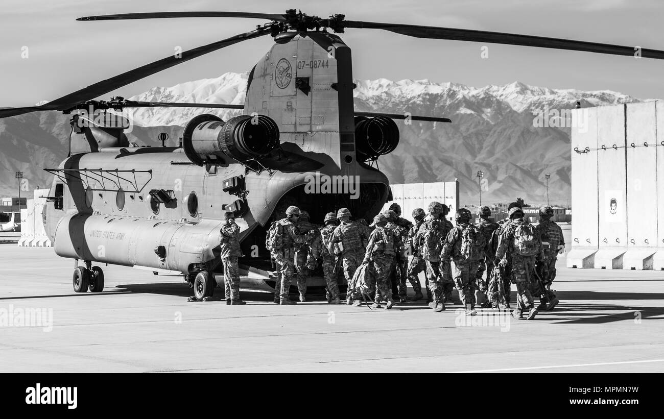 U.S. Army Soldiers assigned to 1st Squadron, 14th Cavalry Regiment, 1st Stryker Brigade Combat Team, 2nd Infantry Division load onto a CH-47 Chinook helicopter assigned to Task Force Flying Dragon, 16th Combat Aviation Brigade, 7th Infantry Division during training at Bagram Airfield, Afghanistan, April 1, 2017. The Cavalry troopers provide a ready response force for downed aircraft, and the training focused on preparing them to assume their mission in support of Operation Freedom’s Sentinel and Resolute Support Mission. Stock Photo