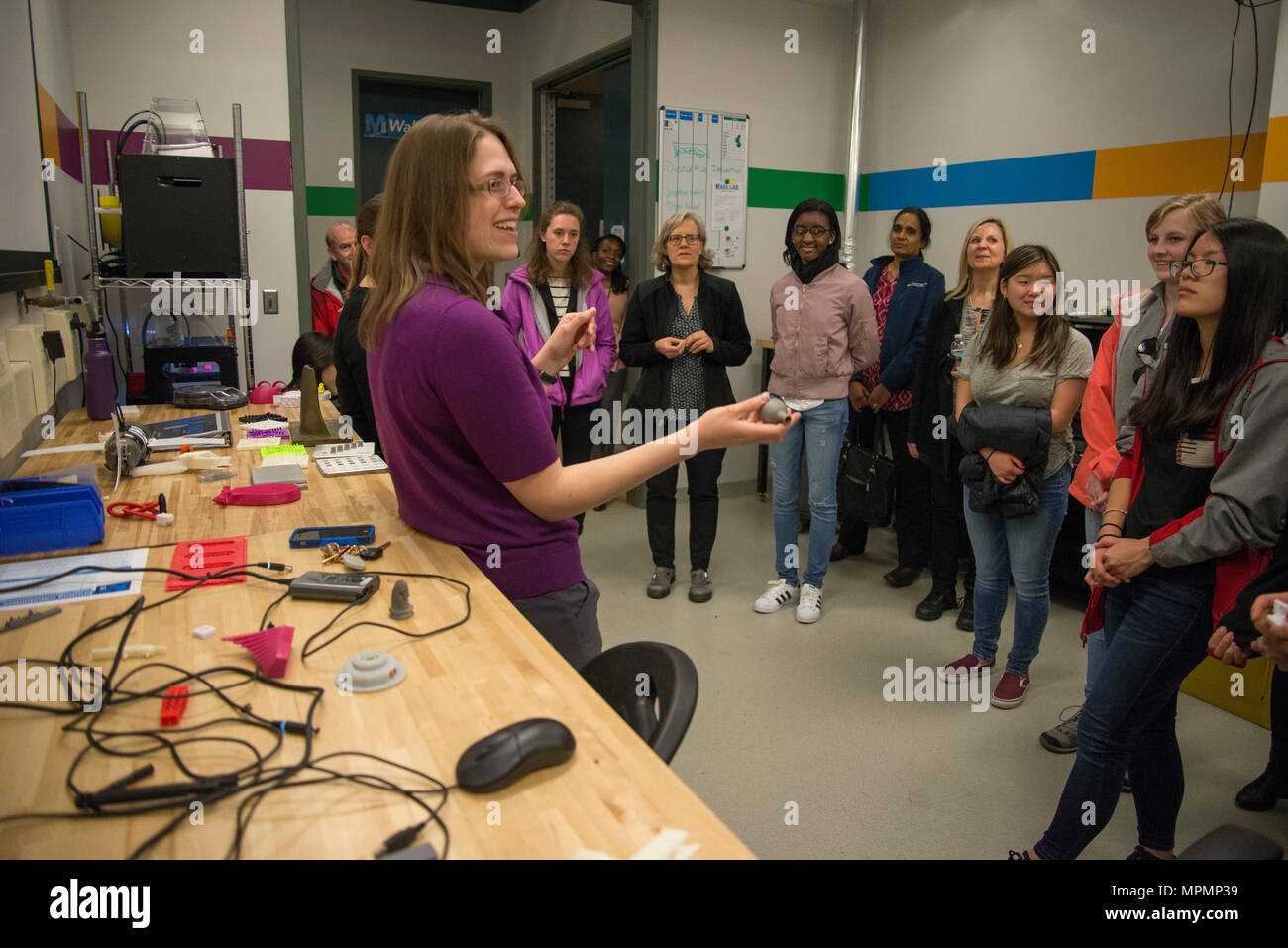 Caroline Scheck, a mechanical engineer with the Additive Manufacturing  Project Office (Code 6103), tells middle- and high-school students with the  Washington, D.C., Girls in Technology (GIT) program about the  Manufacturing, Knowledge and