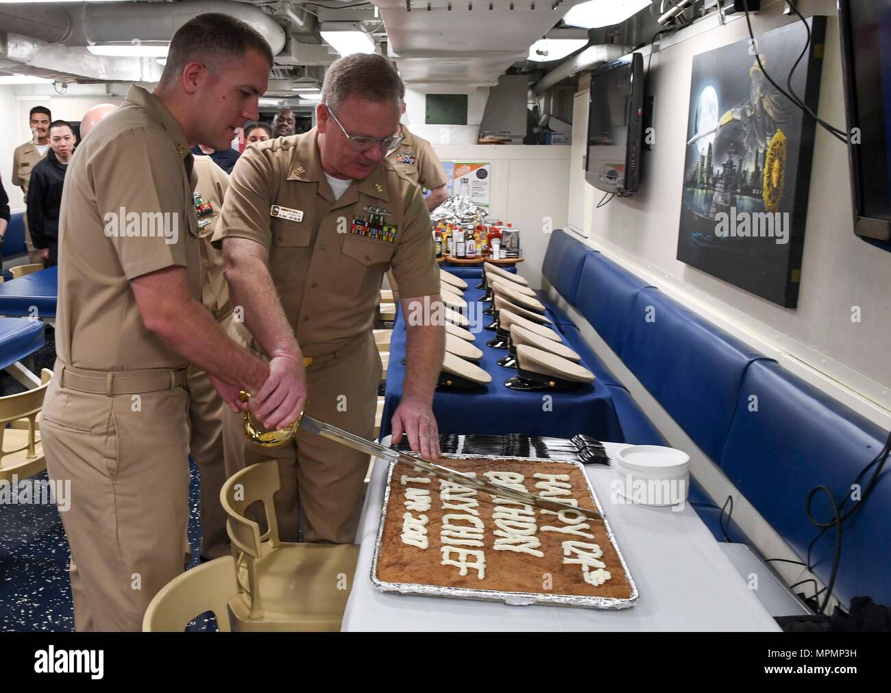 170401-N-RM689-069  SOUTH CHINA SEA (April 1, 2017) Chief Cryptologic Technician Michael Clements (left), from Colorado Springs, Colorado, and Master Chief Electrician’s Mate Raymond Abernathy, from Roundrock, Texas, cut the cake during the chief petty officer birthday celebration aboard Arleigh Burke-class guided-missile destroyer USS Wayne E. Meyer (DDG 108). Wayne E. Meyer is on a regularly scheduled Western Pacific deployment with the Carl Vinson Carrier Strike Group as part of the U.S. Pacific Fleet-led initiative to extend U.S. 3rd Fleet command and control functions into the Indo-Asia-P Stock Photo