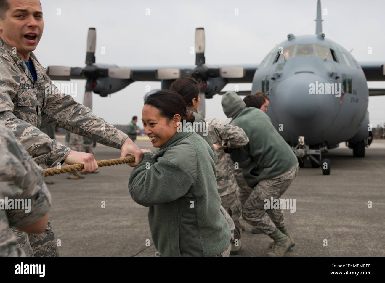 Airmen with the 374th Maintenance Squadron pull a C-130H Hercules at Yokota Air Base, Japan, March 31, 2017. Four teams from 374th Aircraft Maintenance Squadron, 374th MXS, 374th MXG, and 730th Air Mobility Squadron pulled a C-130H to win points toward a Sprit Award, an internal award given to the 'best' squadron. (U.S. Air Force photo by Yasuo Osakabe) Stock Photo