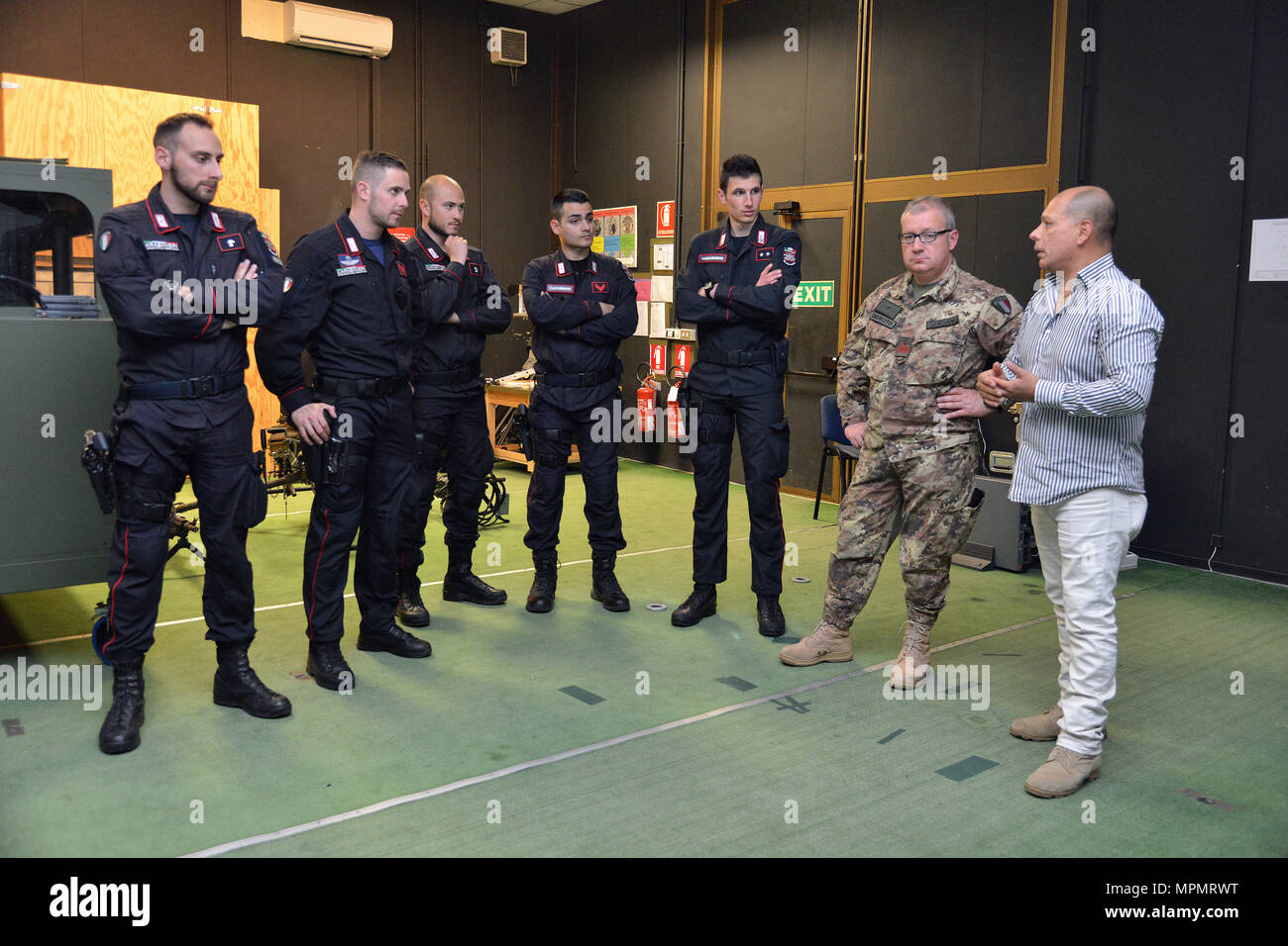 Joseph Gallegos, Training Specialist, Training Support Center Italy, shows the Engagement Skills Trainer (EST) to the Italian Carabinieri of the 13th Regiment Carabinieri “ Friuli Venezia Giulia” Gorizia, during the training at Caserma Ederle, April 3, 2017, Vicenza, Italy. Carabinieri use U.S. Army RTSD South equipment to enhance bilateral relations and to expand levels of cooperation and the capacity of the personnel involved in joint operations. (U.S. Army photo by Visual Information Specialist Paolo Bovo/released) (U.S. Army photo by Visual Information Specialist Paolo Bovo/Released) Stock Photo