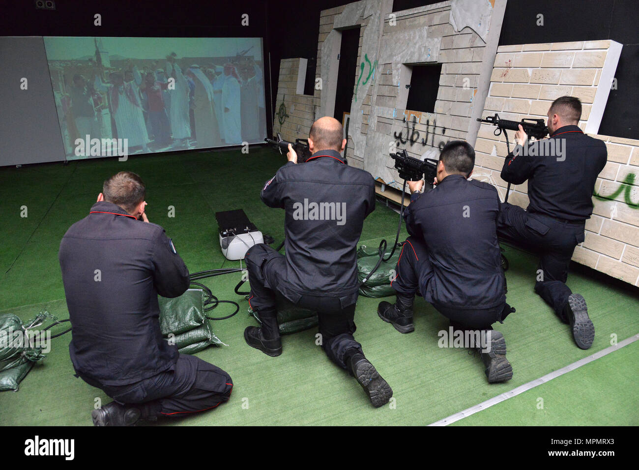Italian Carabinieri of the 13th Regiment Carabinieri “ Friuli Venezia Giulia” Gorizia, conduct training using Engagement Skills Trainer (EST) at Caserma Ederle Vicenza, Italy, April 3, 2017. Carabinieri use U.S. Army RTSD South equipment to enhance bilateral relations and to expand levels of cooperation and the capacity of the personnel involved in joint operations. (U.S. Army photo by Visual Information Specialist Paolo Bovo/released) Stock Photo