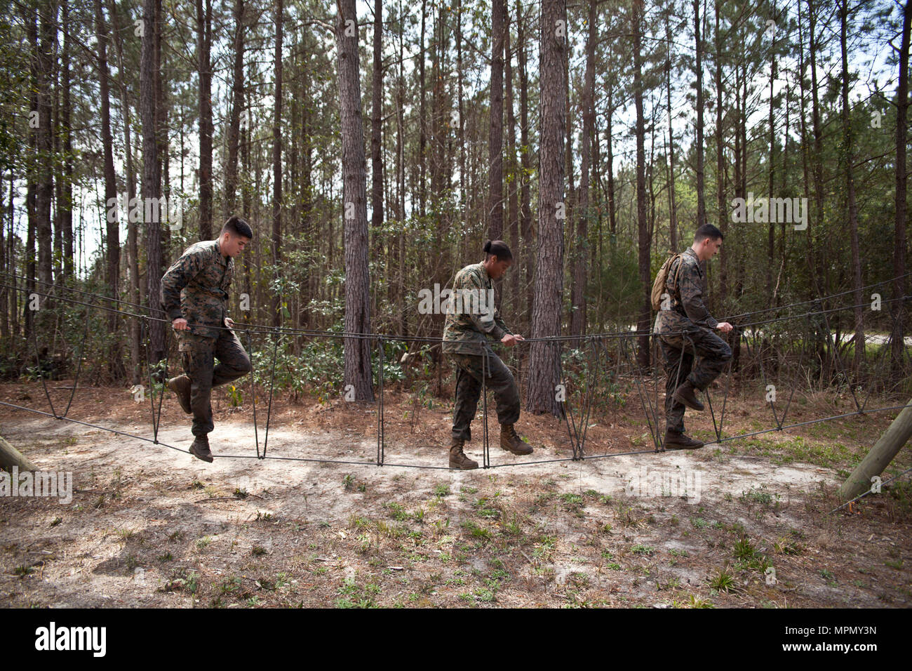 Marines at Ground Supply School complete a rope bridge obstacle during ...