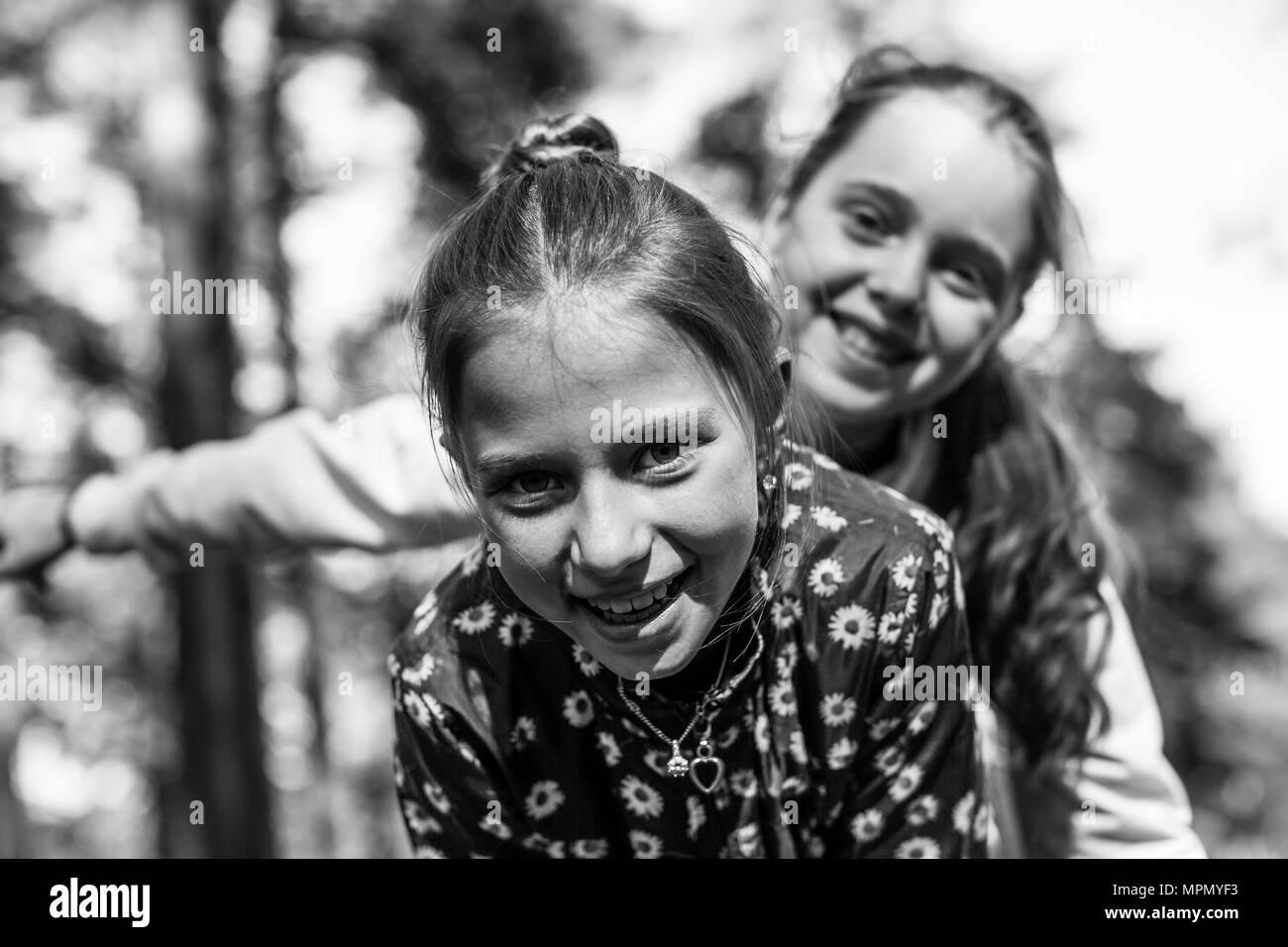 Two girls sisters or girlfriends having fun outdoors. Black and white photo. Stock Photo