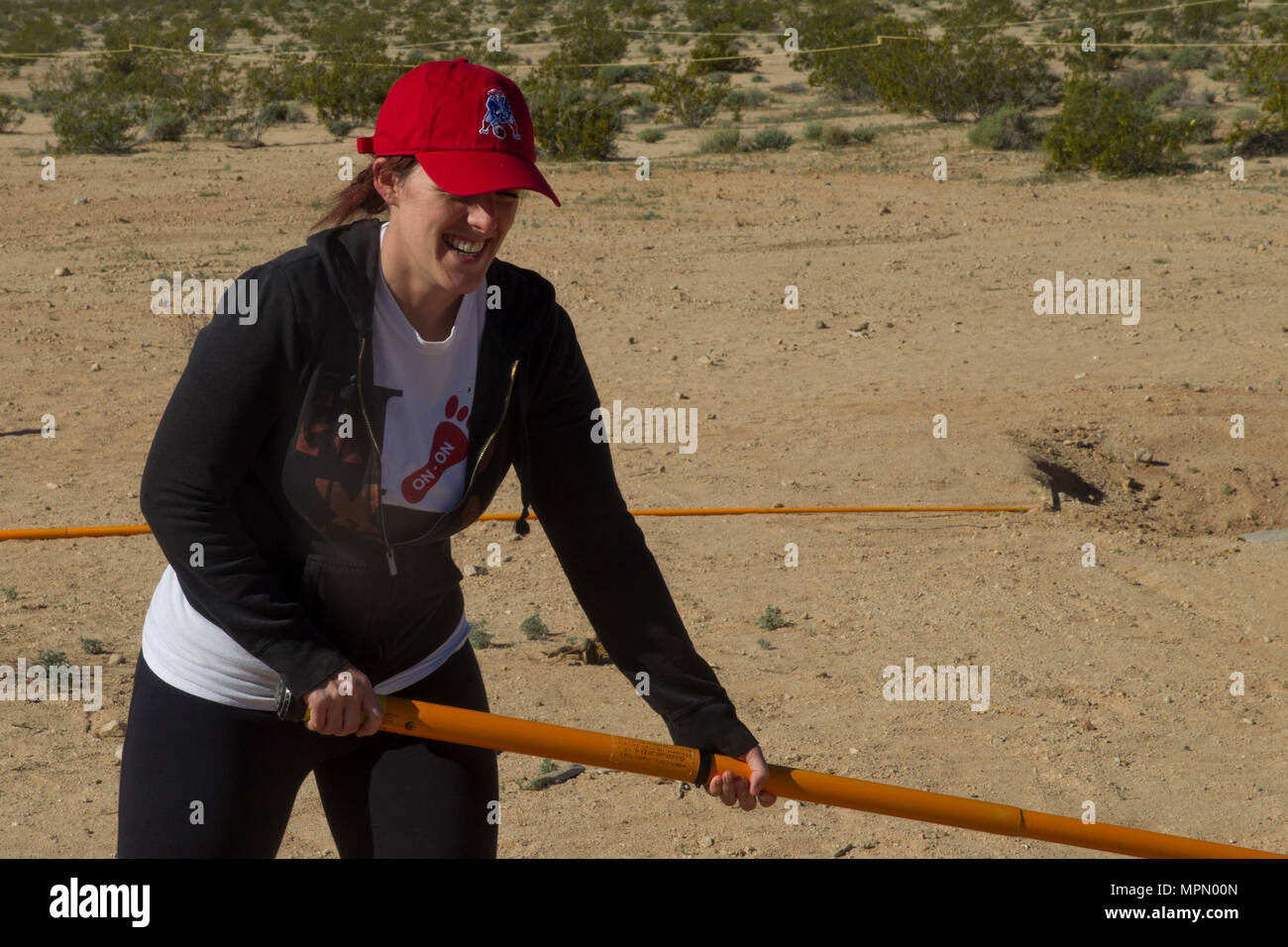 Annie Stump, wife of Sgt. Myles Stump, Marine Corps Communications Electronics School, uses a Holley stick at Range 800 aboard Marine Corps Air Ground Combat Center, Twentynine Palms, Calif., March 30, 2017. The Holley stick is a tool used exclusively by Marine Corps Explosive Ordnance Disposal technicians that provides them with the capability to investigate and manipulate a suspect IED from a stand-off distance.  (U.S. Marine Corps photo by Cpl. Connor Hancock) Stock Photo