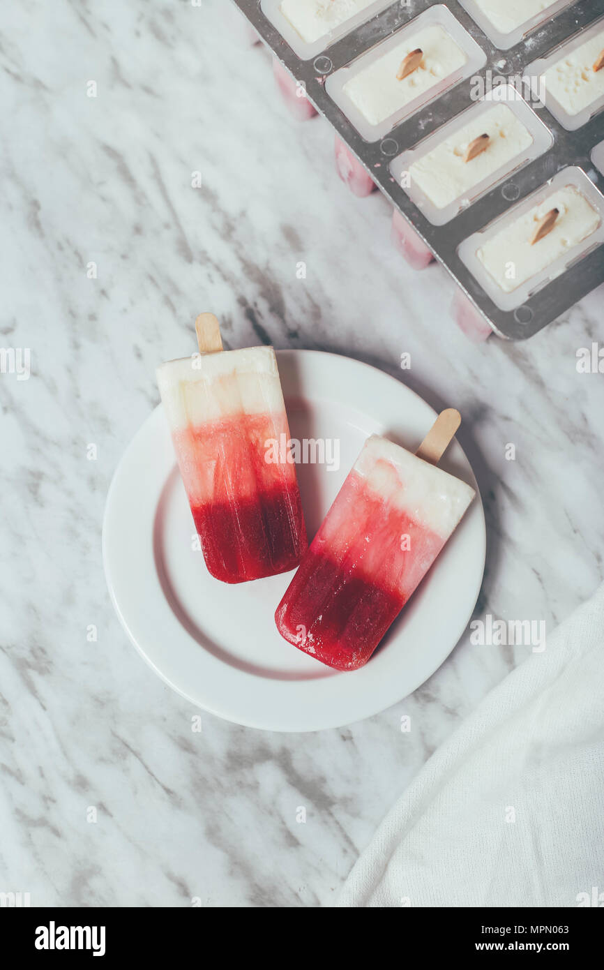 Homemade strawberry and yogurt ice lollies Stock Photo Alamy
