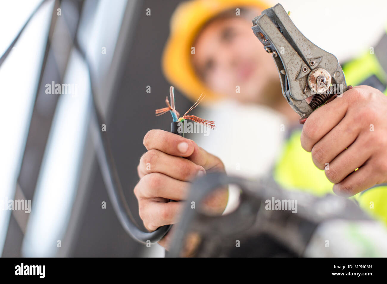 Close-up of electrician working with wire cutter Stock Photo