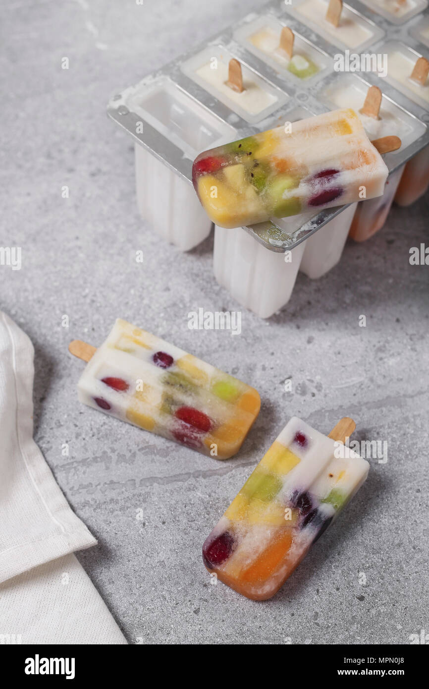 Homemade fruits and yogurt ice lollies on marble Stock Photo Alamy