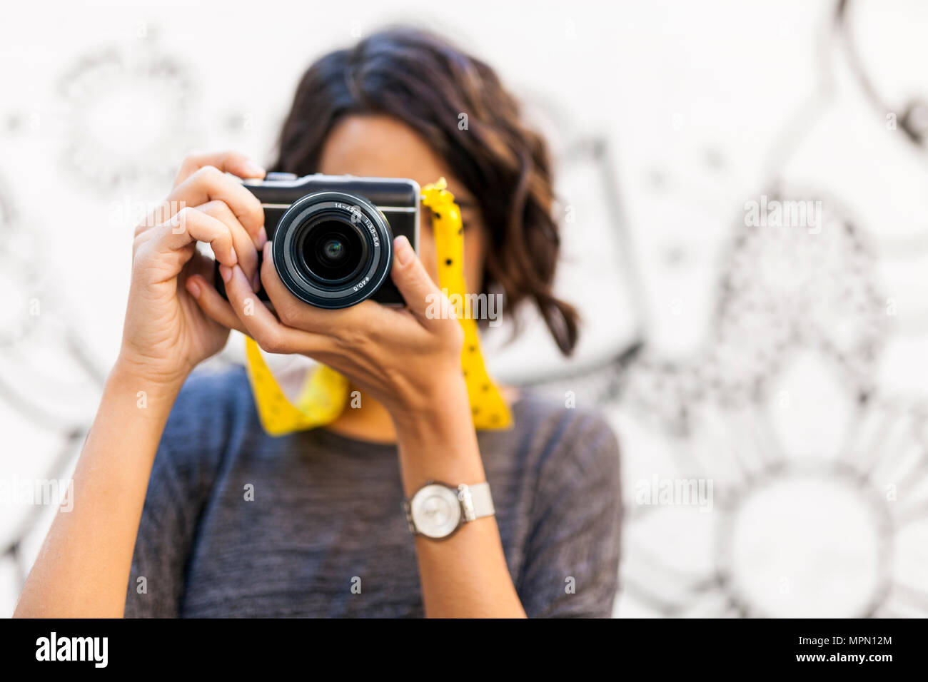 Close-up of woman taking a picture with camera Stock Photo