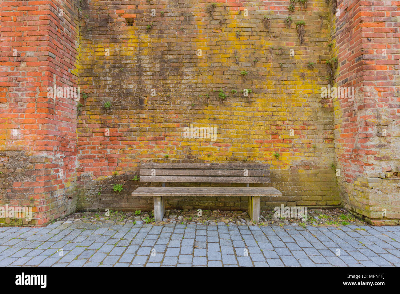 Germany, Bavaria, Memmingen, wooden bench and city wall Stock Photo