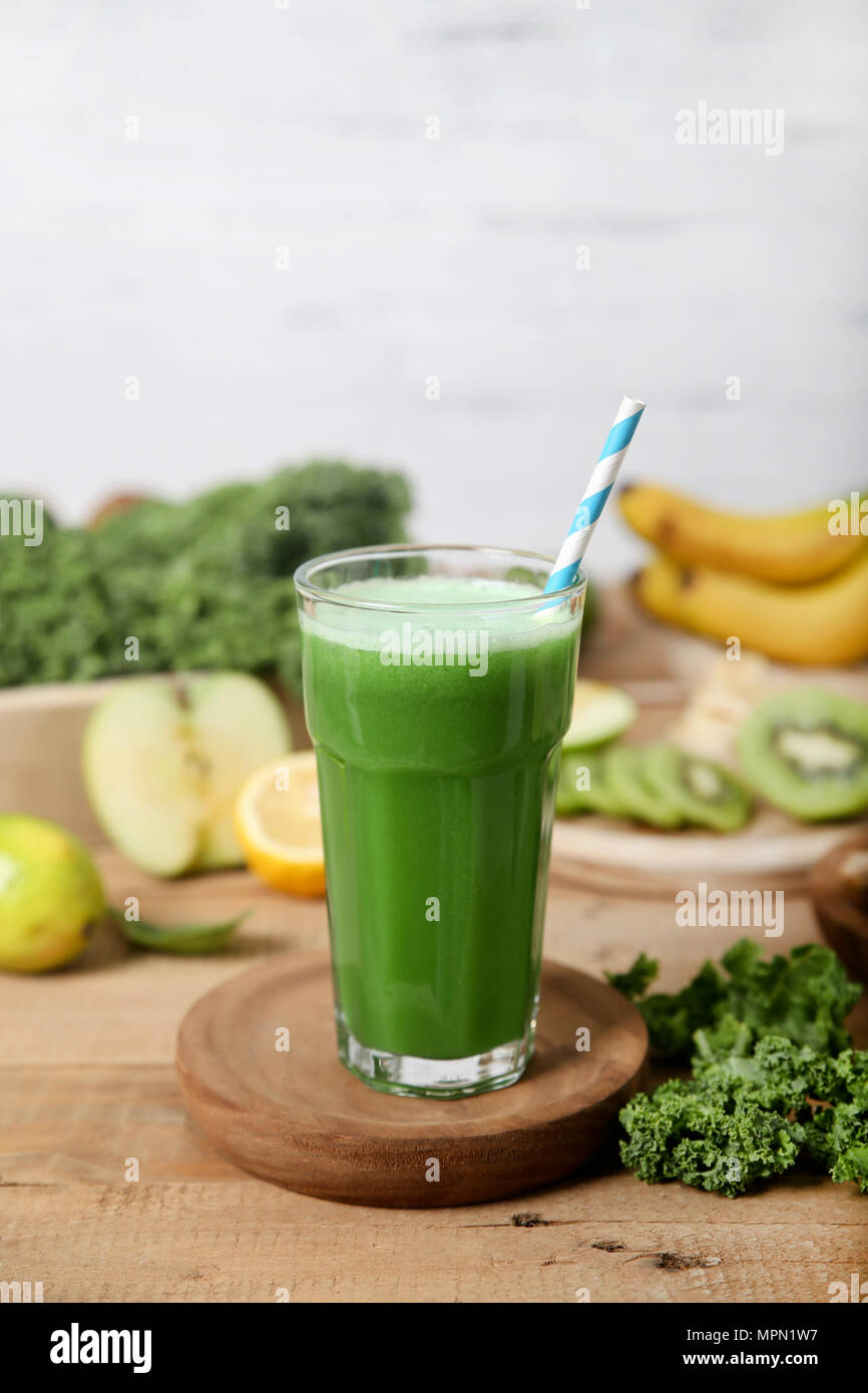 Green smoothie surrounded by ingredients Stock Photo