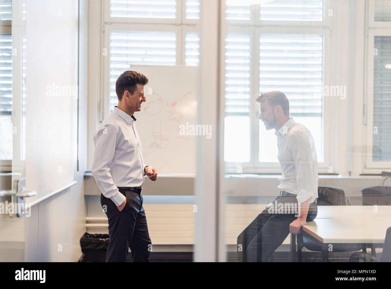 Two businessman having a meeting in office Stock Photo - Alamy