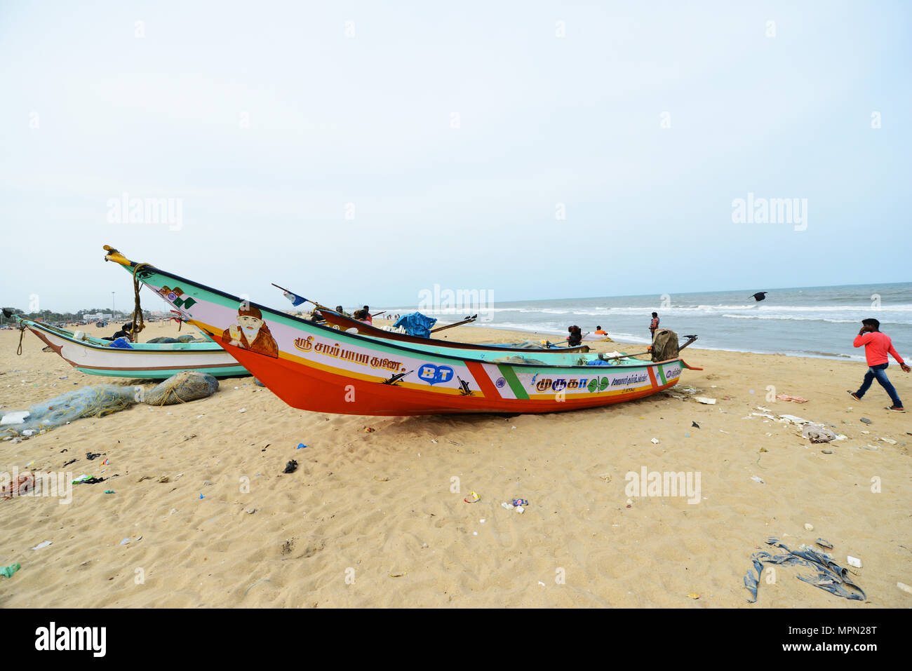 Fishermen and fishing boats on Marina beach in Chennai, India Stock