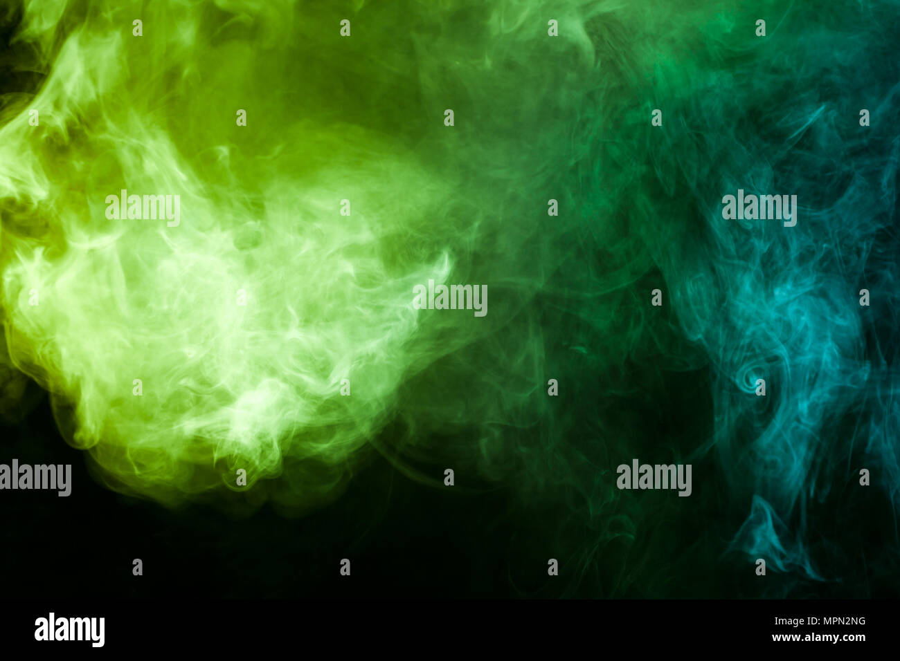 Green and blue smoke on black background Stock Photo - Alamy
