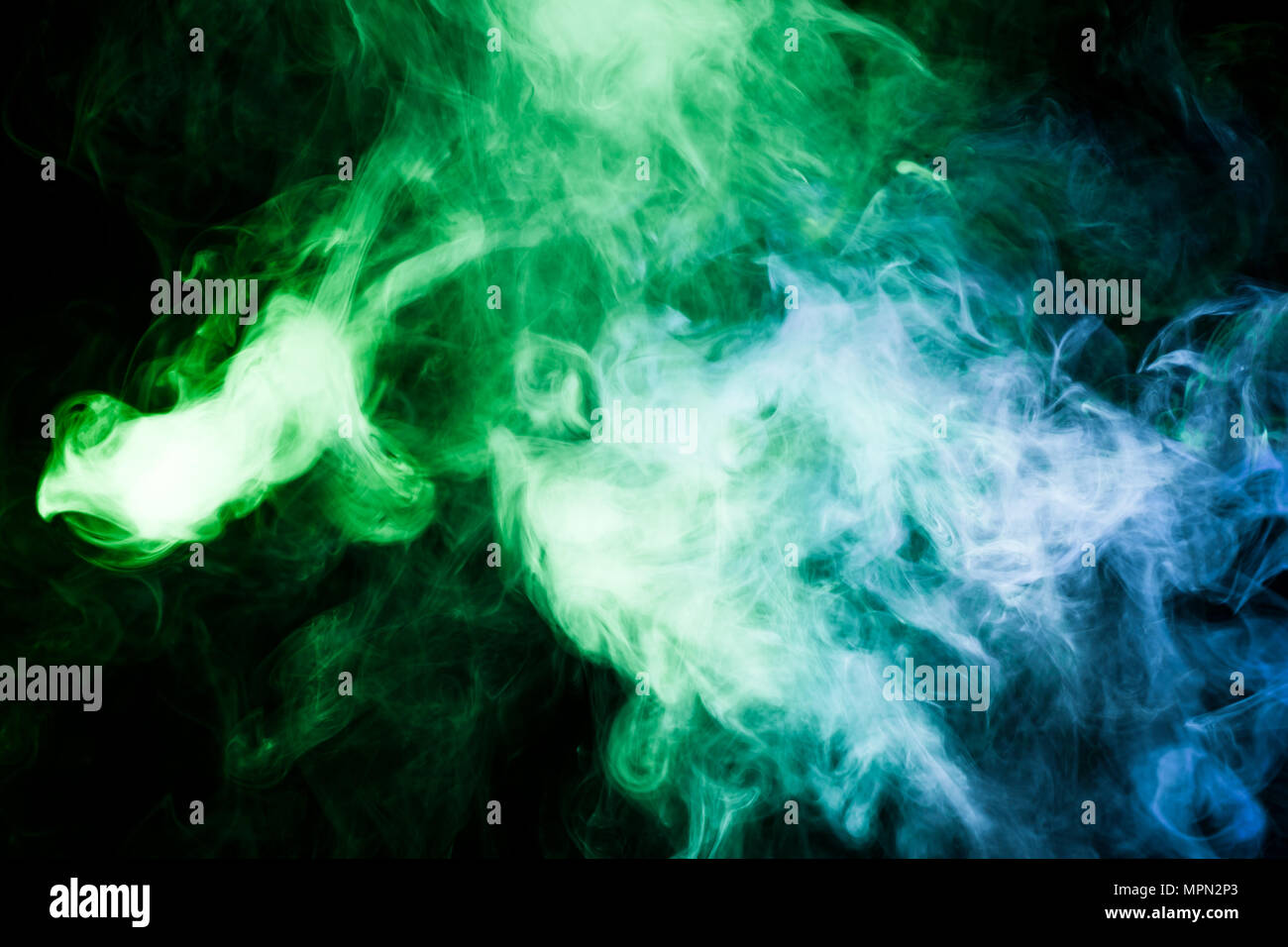Green and blue smoke on black background Stock Photo - Alamy