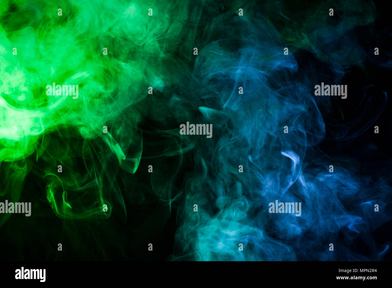 Green and blue smoke on black background Stock Photo - Alamy