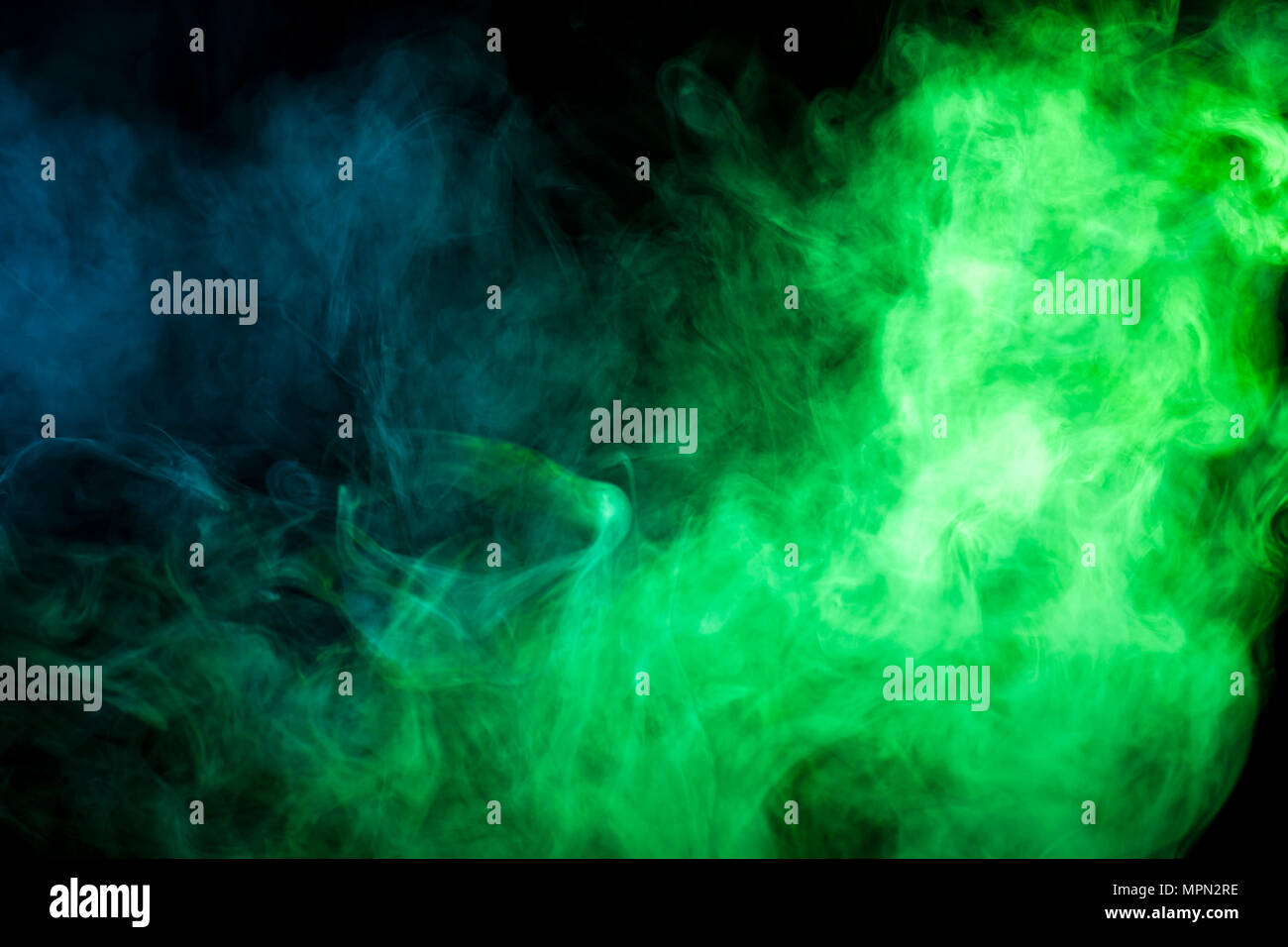 Green and blue smoke on black background Stock Photo - Alamy
