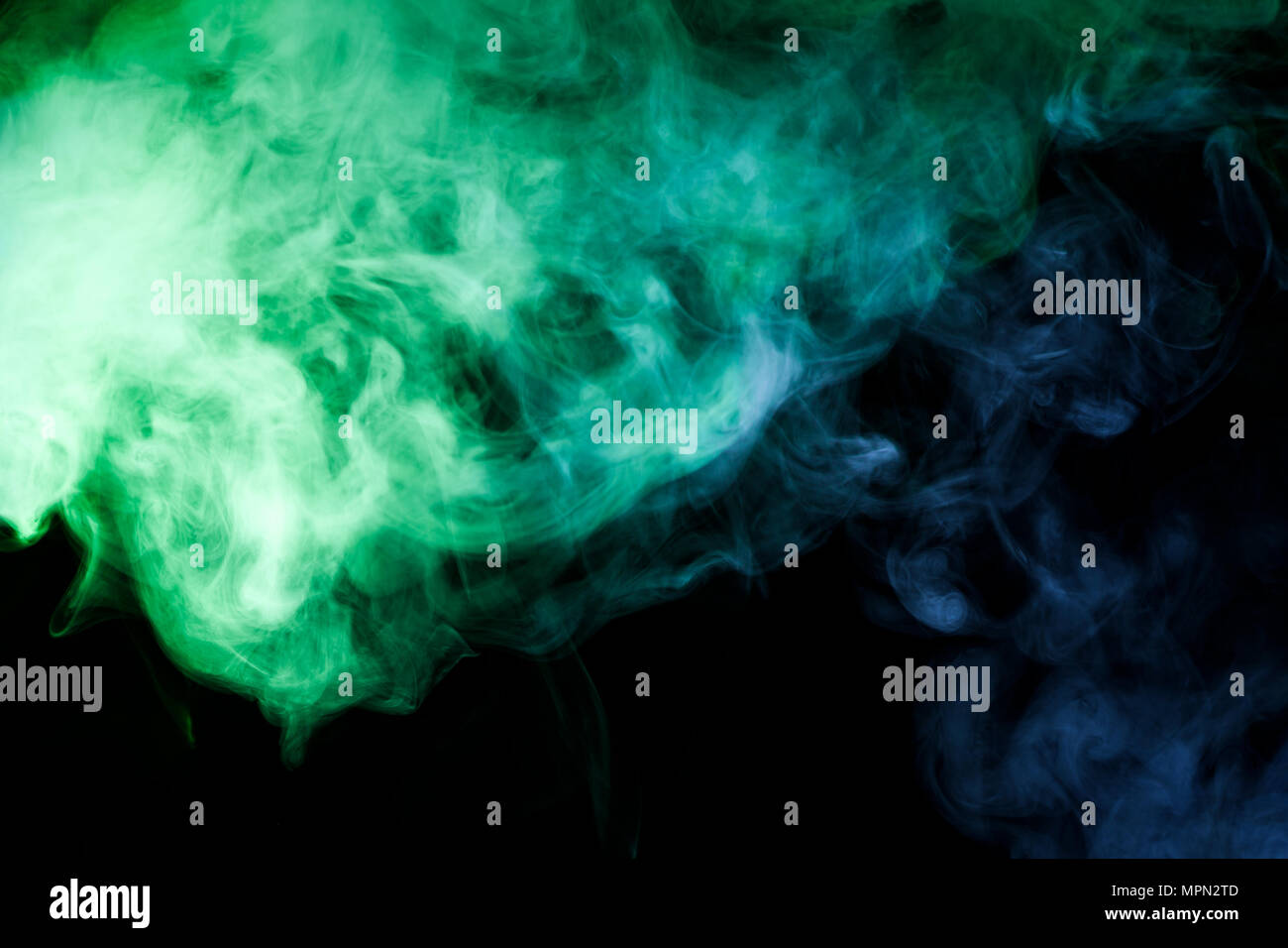 Blue and green smoke on black background Stock Photo - Alamy