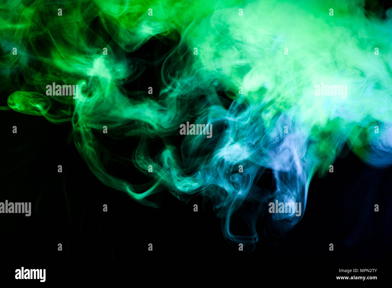 Blue and green smoke on black background Stock Photo - Alamy