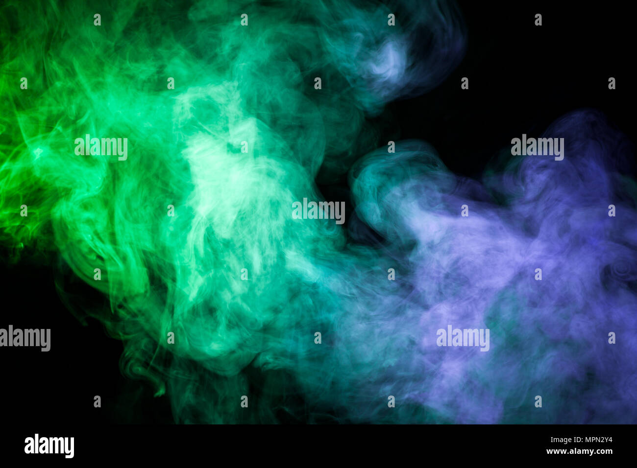 Blue and green smoke on black background Stock Photo - Alamy