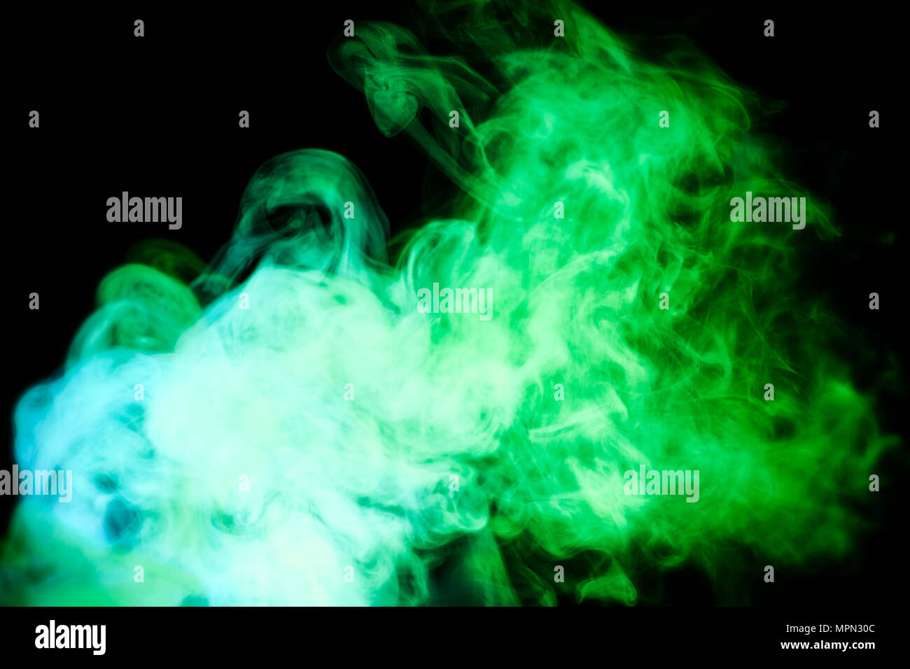 Green and yellow cloud of smoke of black isolated background