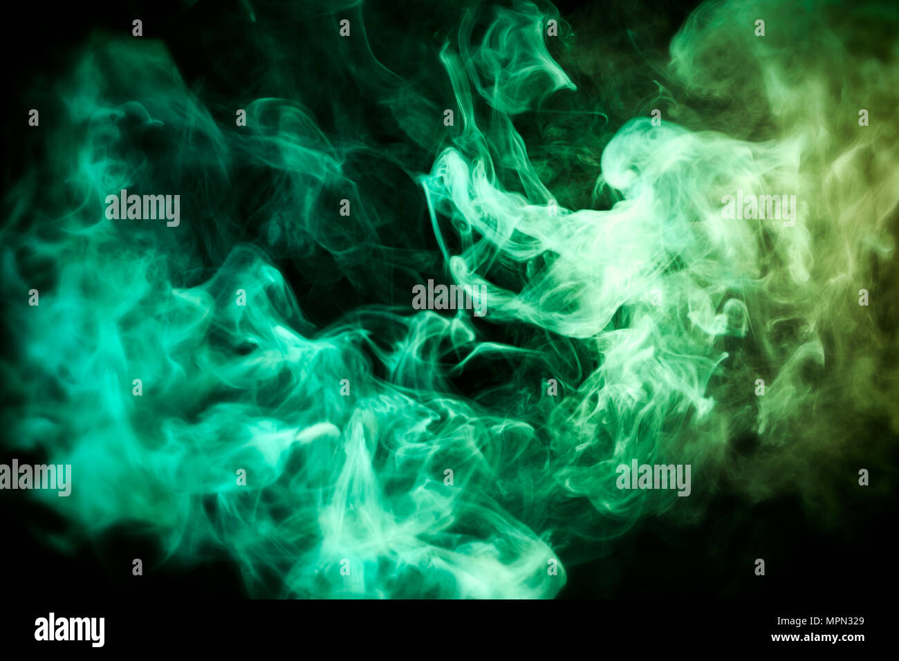 Green and yellow cloud of smoke of black isolated background