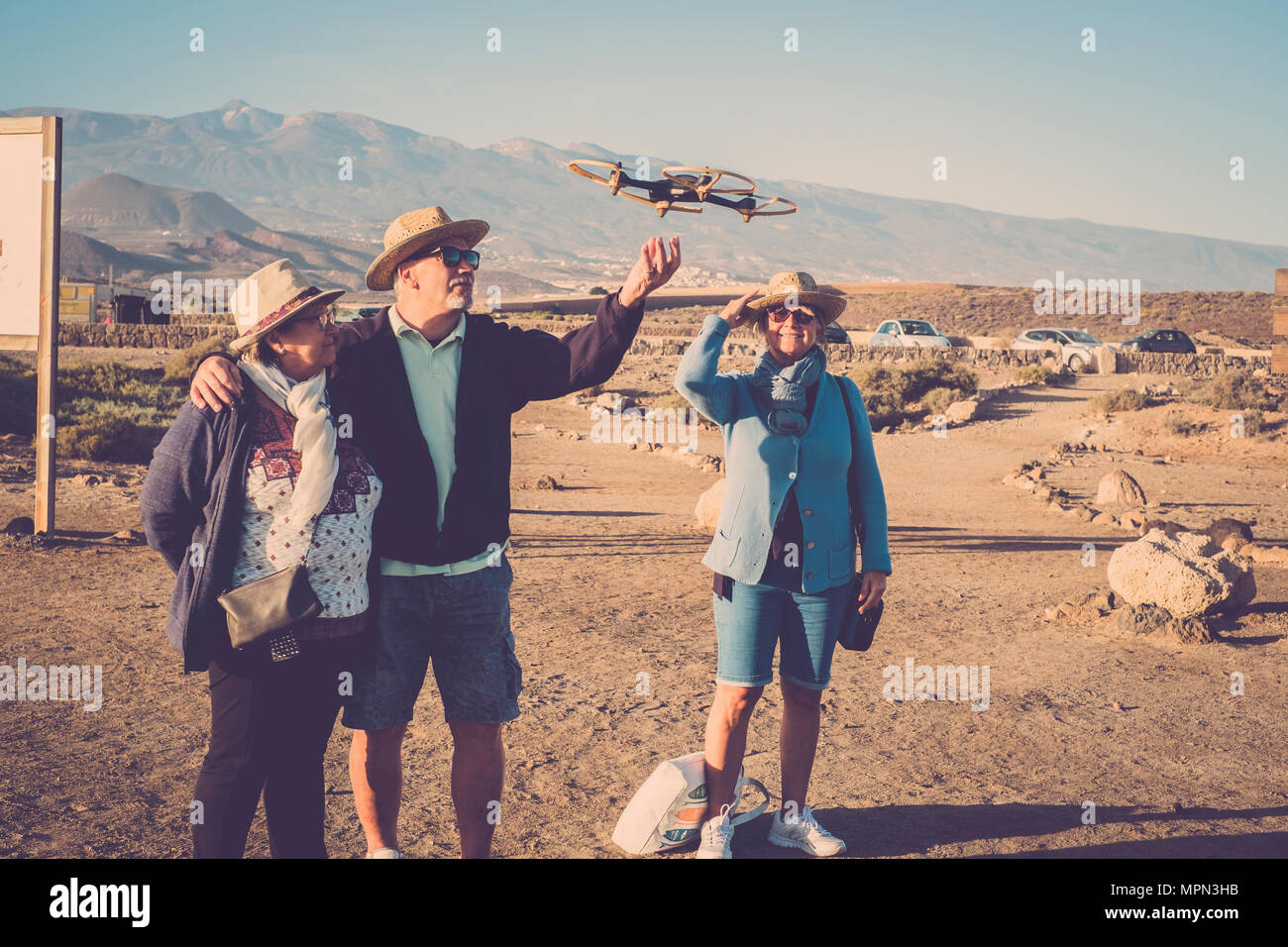 Leisure for seniors man and women looking and touching a flying drone near  a parking outdoor in the parks. Curiosity about the object. Learning concep  Stock Photo - Alamy