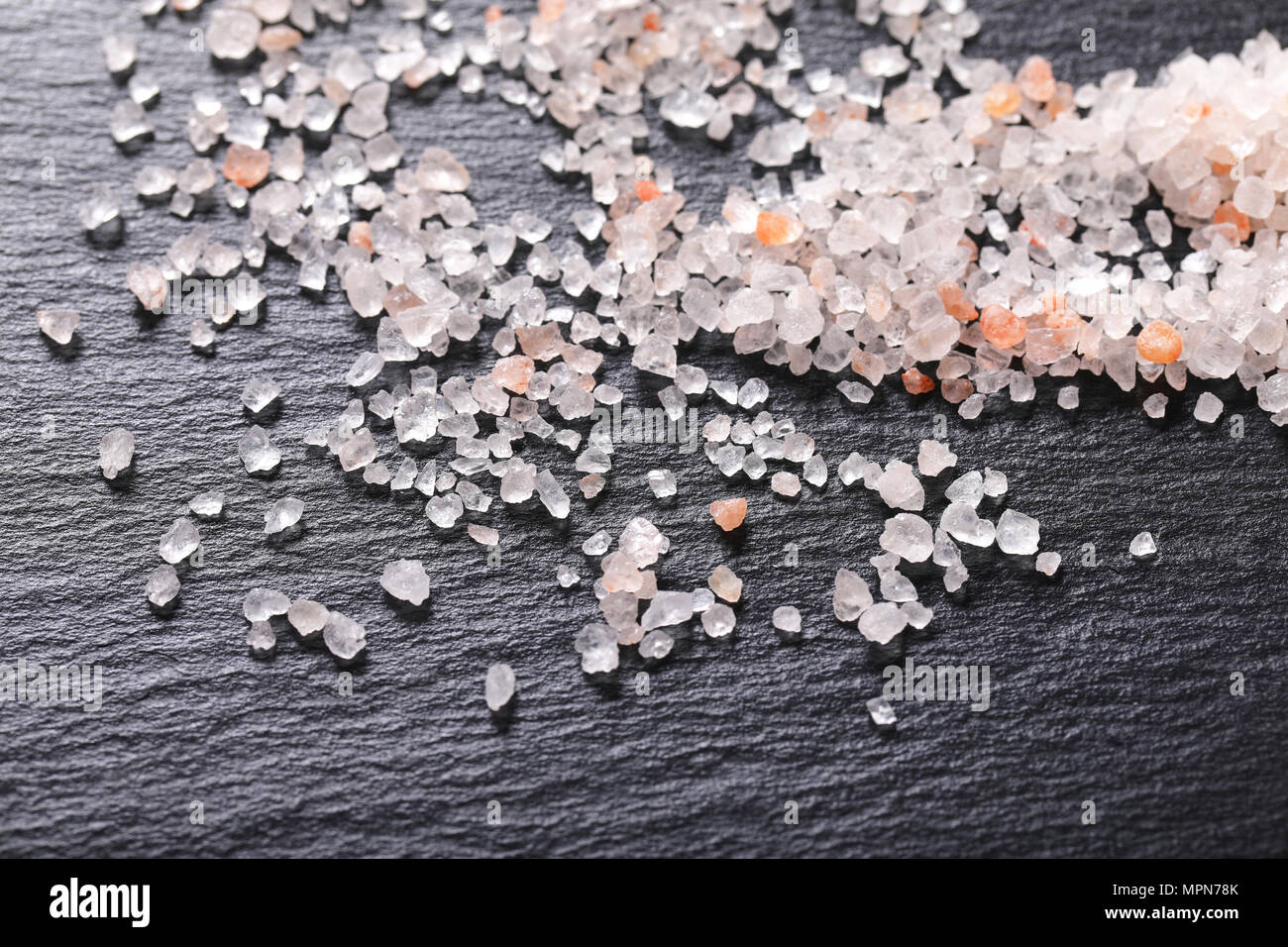 crystals of coarse grained salt on black background Stock Photo
