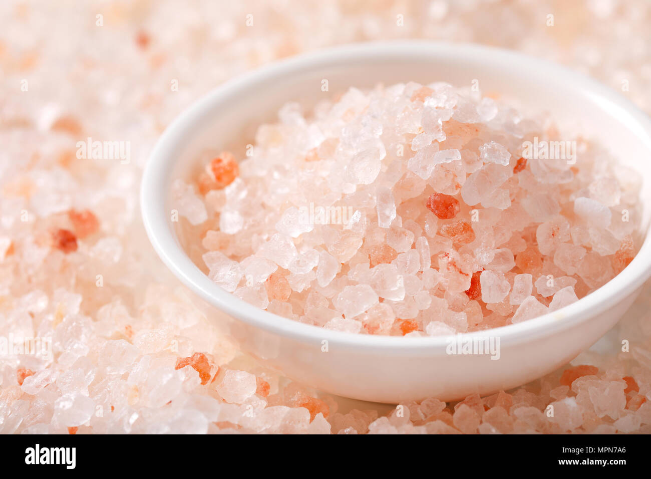 bowl of coarse grained salt on coarse grained salt background - detail Stock Photo