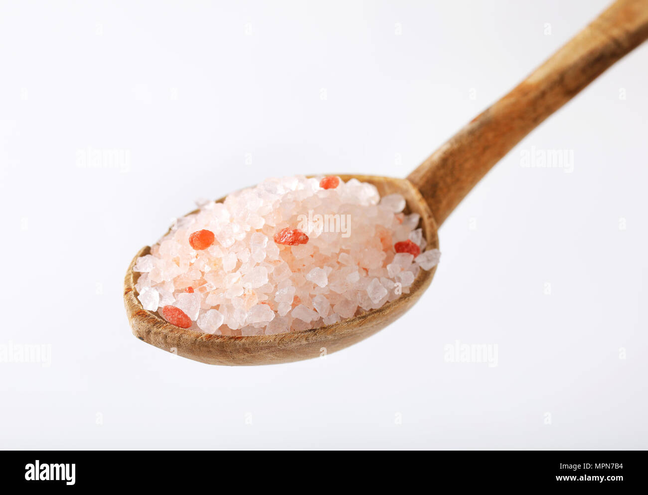 Sharp Salt Stuff spoon of coarse grained salt on white background Stock Photo - Alamy