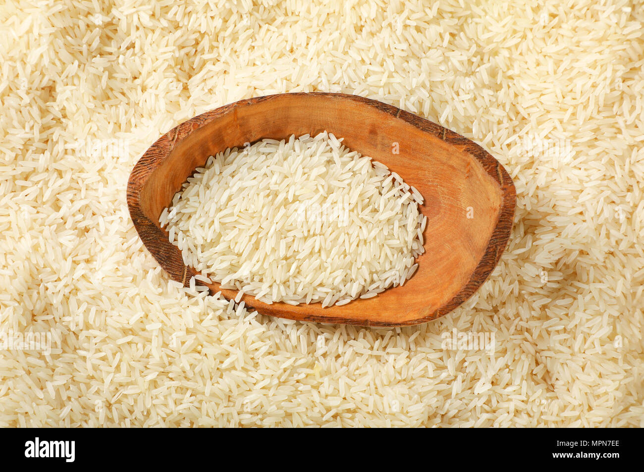 bowl of white long grained rice on rice background Stock Photo