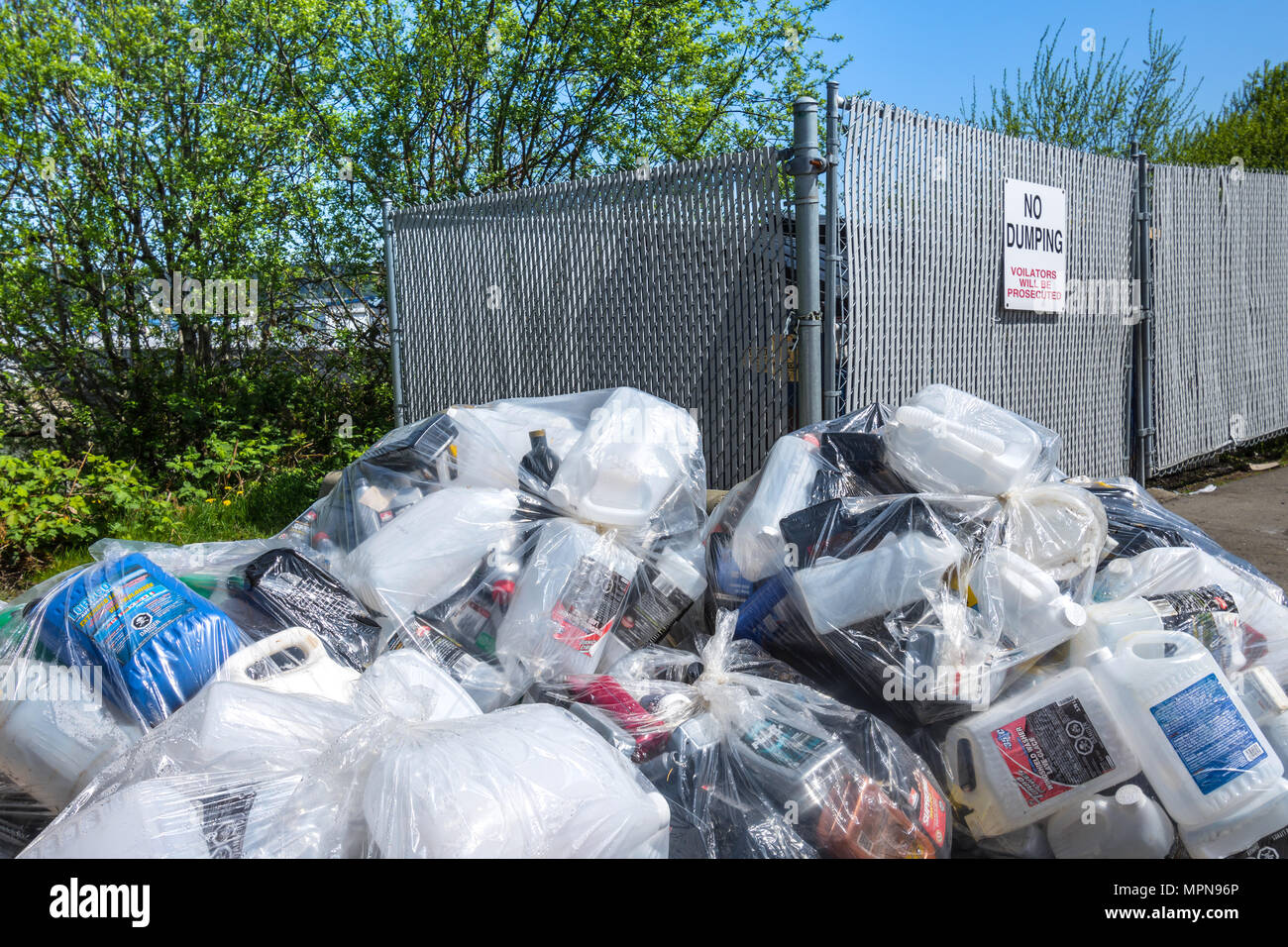 Rubbish dumped next to no dumping sign - Buckley Bay, British Columbia, Canada. Stock Photo