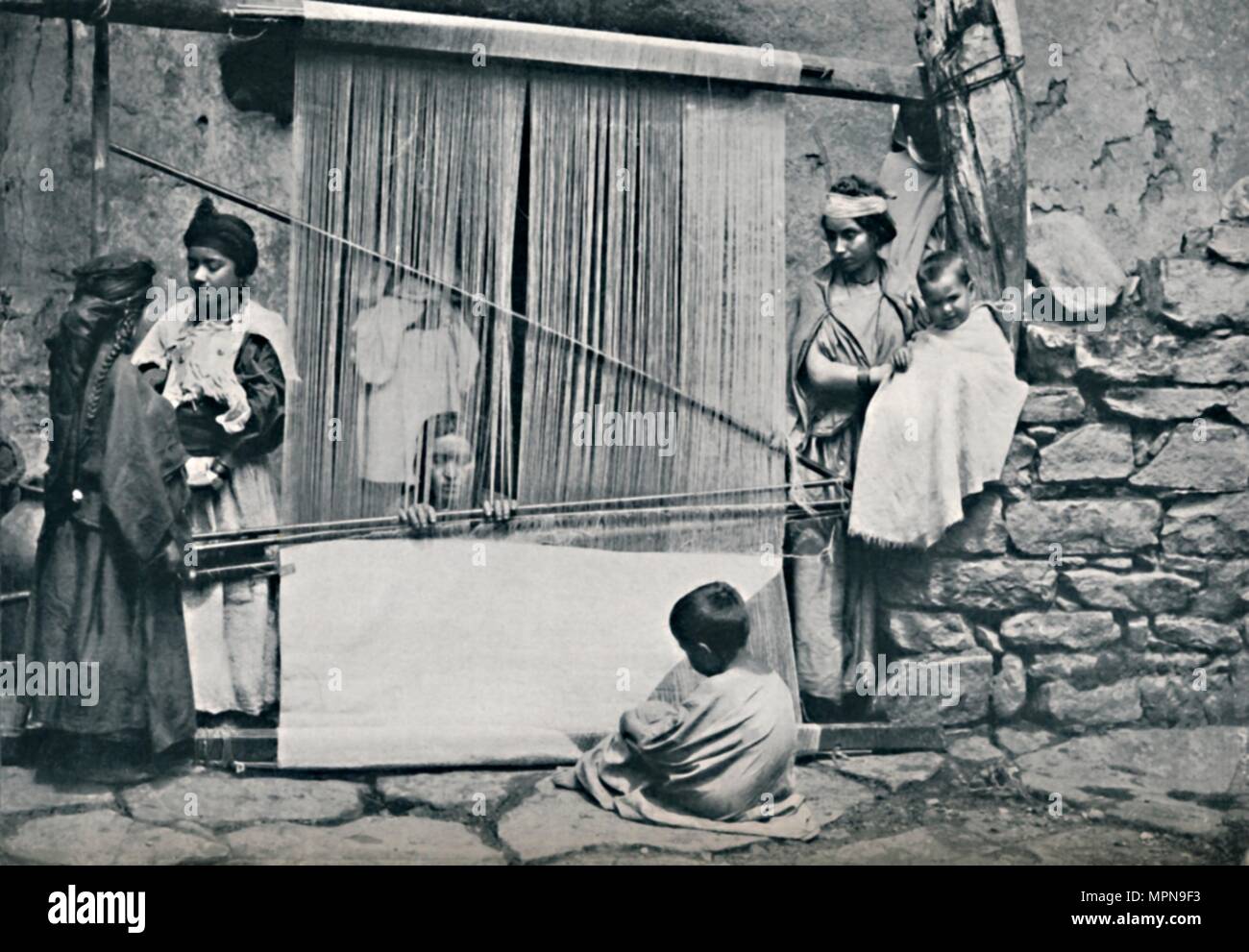 Kabyle weavers and native loom, Northern Algeria, 1912. Artist: Legrand. Stock Photo