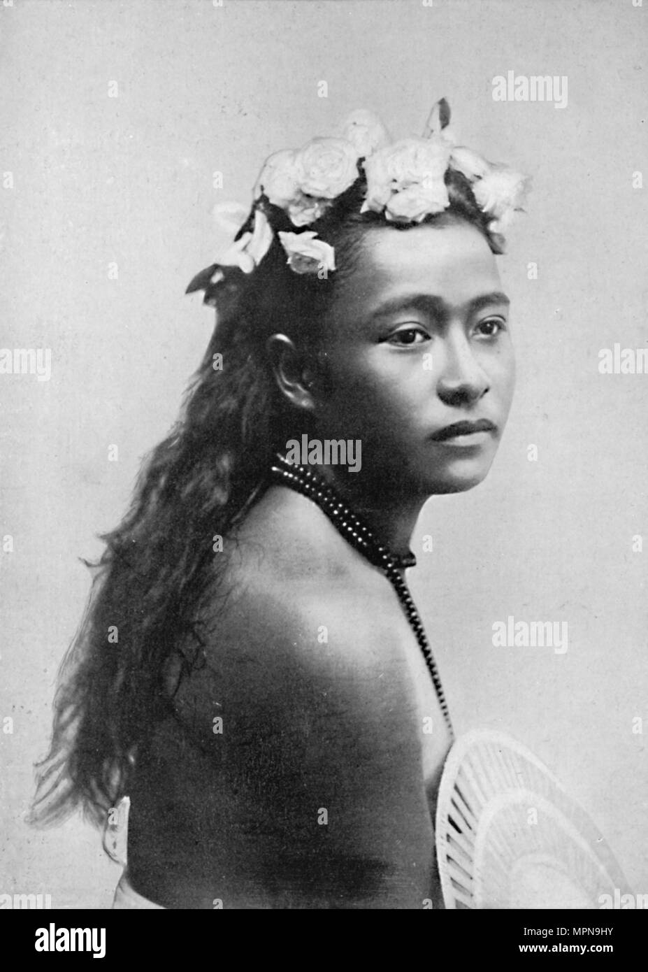 A Samoan girl, with chaplet of hibiscus flowers, 1902. Artist: Thomas Andrew. Stock Photo