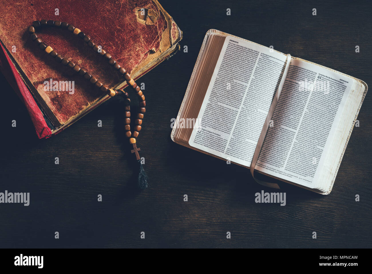 top view of open holy bible with rosary on table Stock Photo