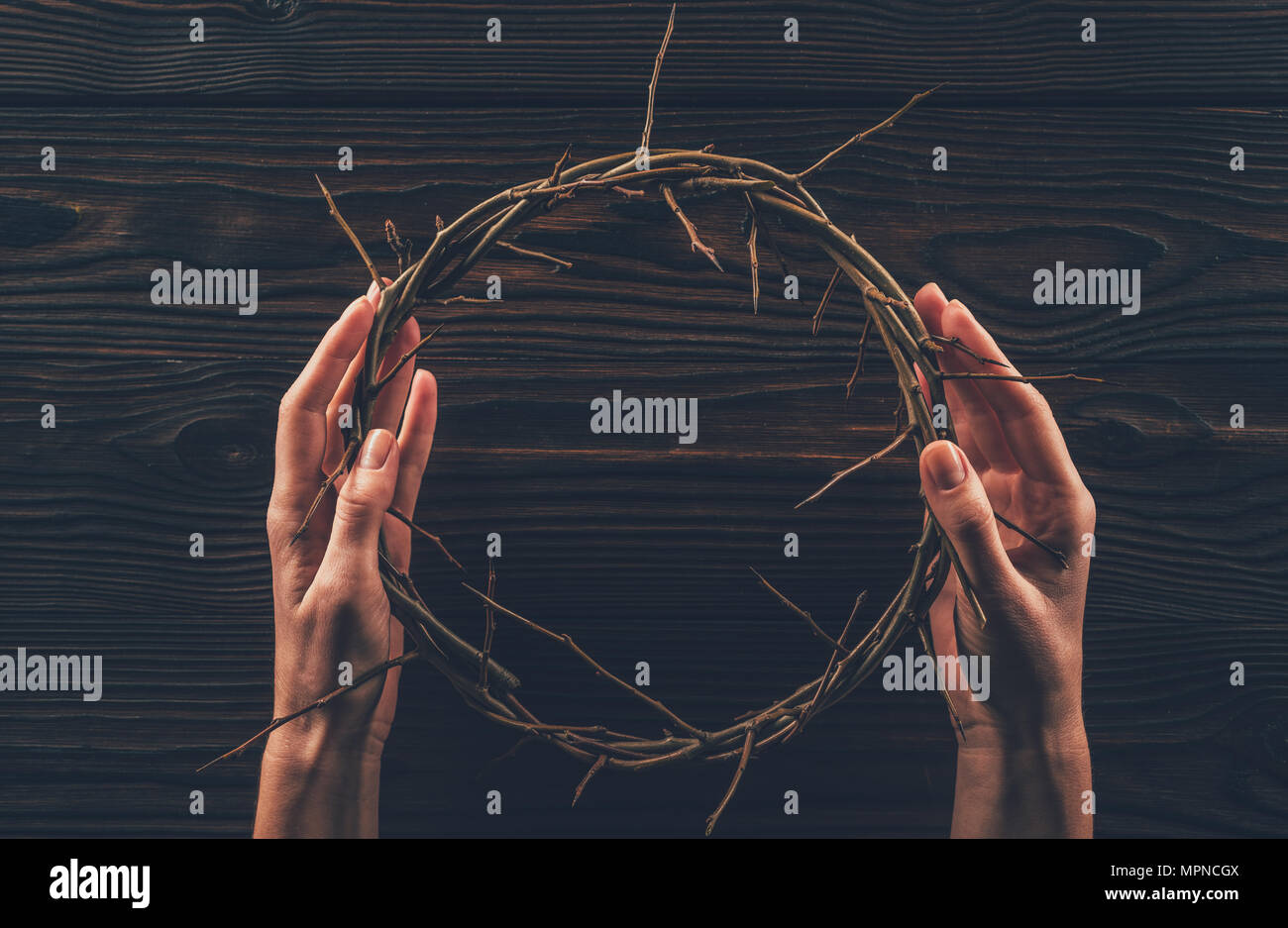 cropped image of woman holding crown of thorns in hands Stock Photo