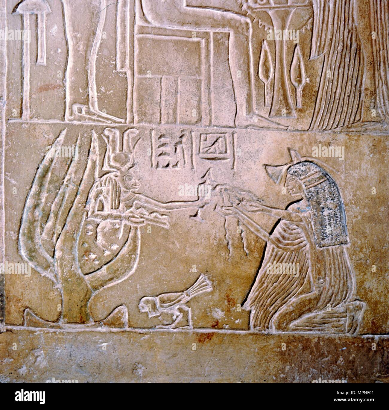 Egyptian relief, deceased priestess and Hathor with sycamore tree. Artist: Unknown. Stock Photo