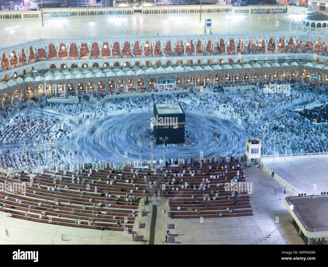 Prayer and Tawaf - circumambulation - of Muslims Around AlKaaba in Mecca, Saudi Arabia, Aerial Top View Stock Photo