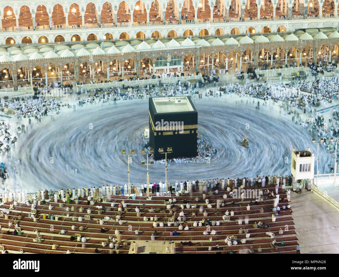 Prayer and Tawaf - circumambulation - of Muslims Around AlKaaba in Mecca, Saudi Arabia, Aerial Top View Stock Photo
