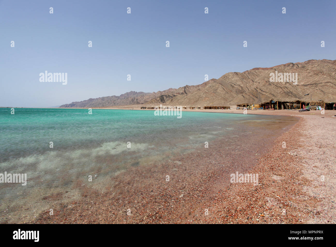 Deserted beaches at the Blue Lagoon (Dahab), Sinai, Egypt Tourist's shanty huts in the background Stock Photo